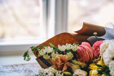 Wreath of flowers beside window